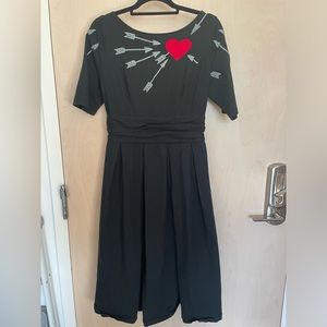 Cute black jersey dress with embroidered heart detail and pockets!